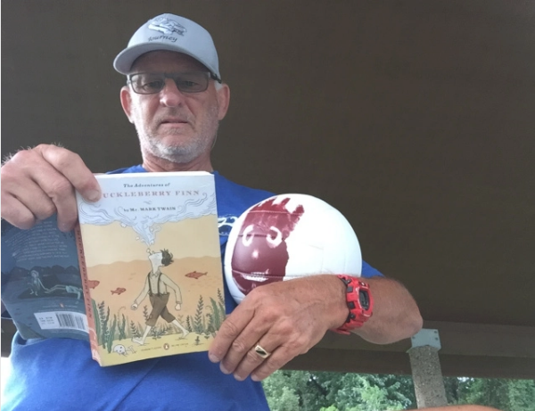 Dave with Wilson (created by his Arizona pickleball family) and a copy of Huck Finn
