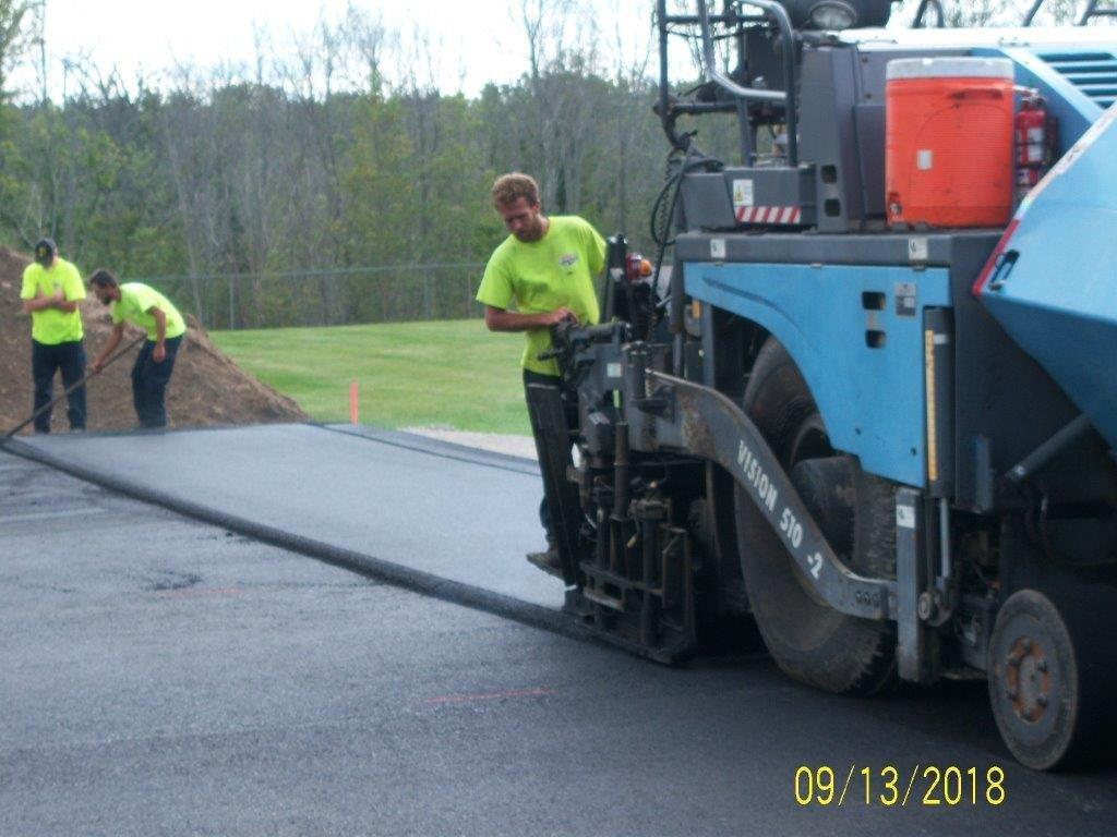 Putting second smooth coat of asphalt down