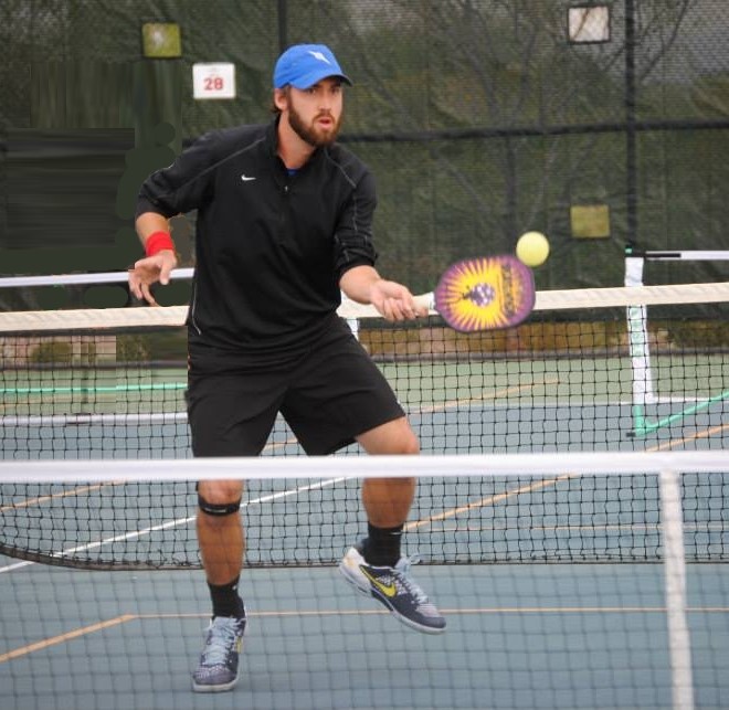 Pickleball Champion Wes Gabrielsen at the net with a Magnum Graphite Stealth pickleball paddle